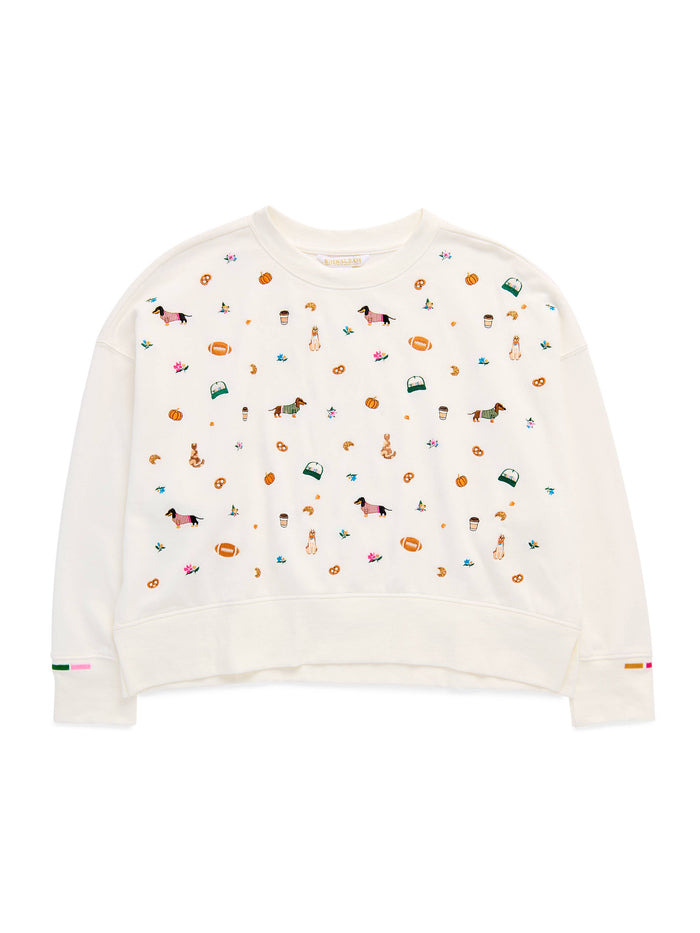 An off-white cropped crewneck sweatshirt featuring a colorful all-over print of equestrian-themed illustrations, including horses, bits, and riding gear, displayed on a clean white background.