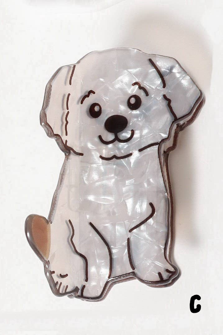 White dog-shaped claw clip with black outline on a white background