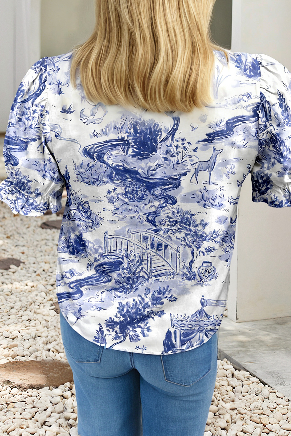 Person wearing a blue and white patterned shirt with rolled-up sleeves.