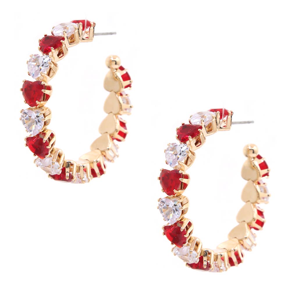 A pair of gold hoop earrings decorated with alternating red heart-shaped crystals and clear round-cut crystals, set against a plain white background.