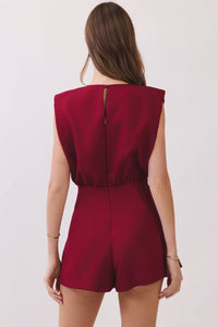 Red romper worn by a person on a white background