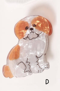 Clear gel pack shaped like a dog with brown and white patches on a white background