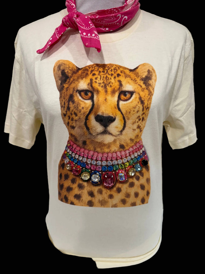 White t-shirt with a cheetah graphic wearing colorful jewelry and a pink bandana.
