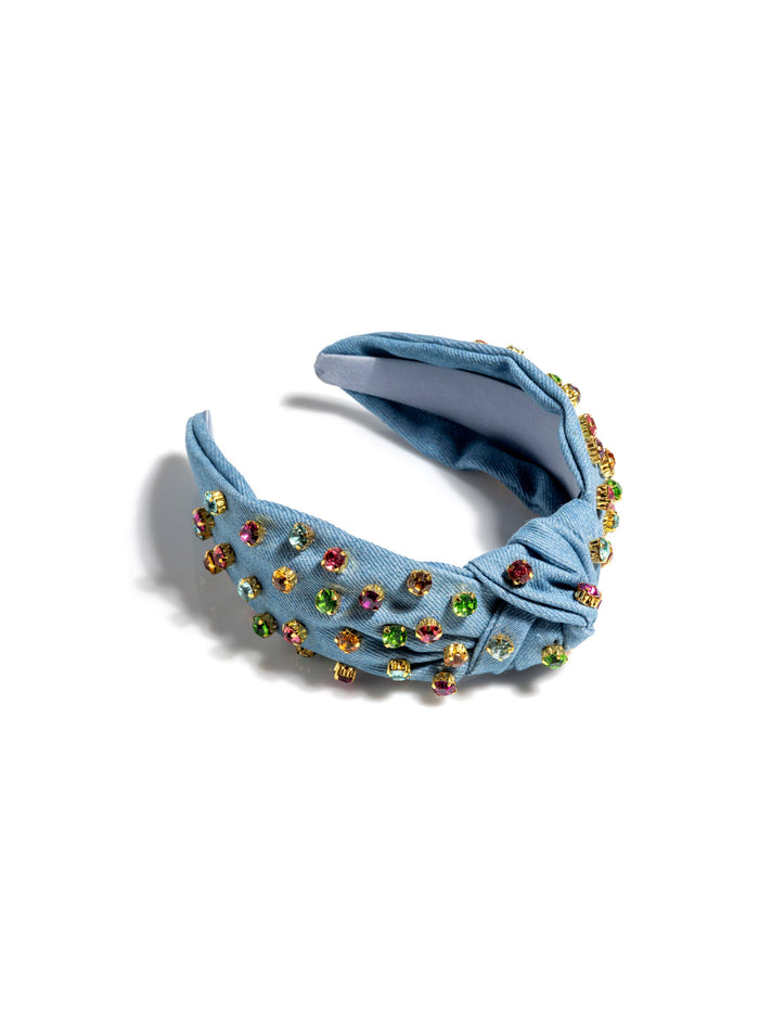 Blue headband with colorful gemstones on a white background