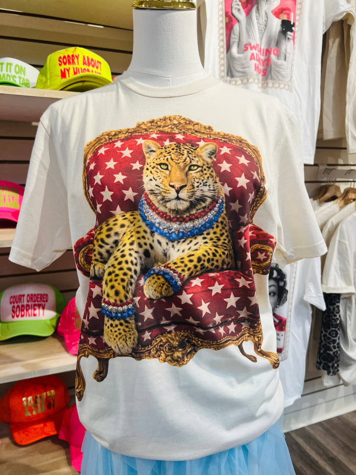 White t-shirt with a leopard graphic on a mannequin in a store setting.