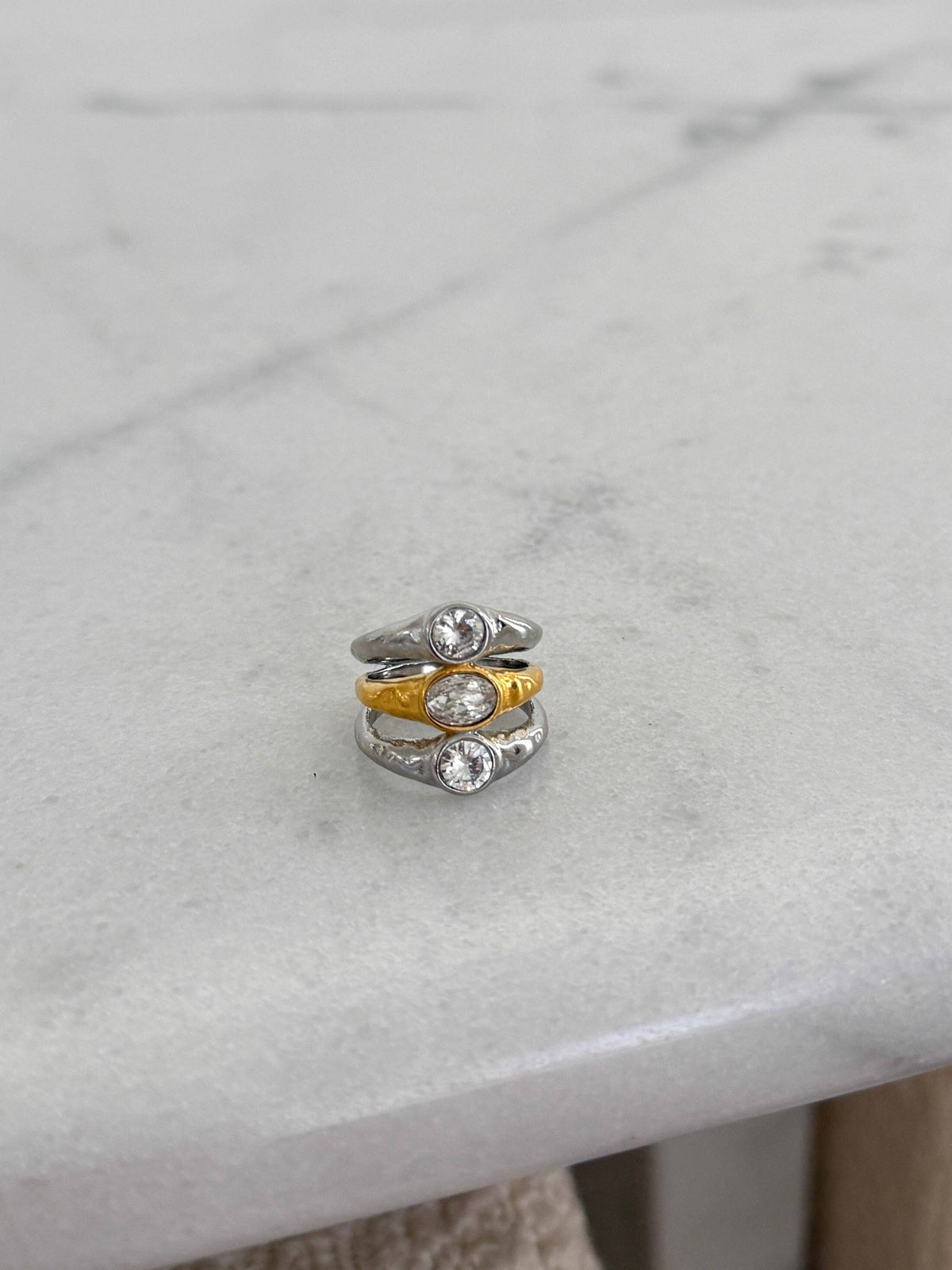 Stack of three rings on a marble surface