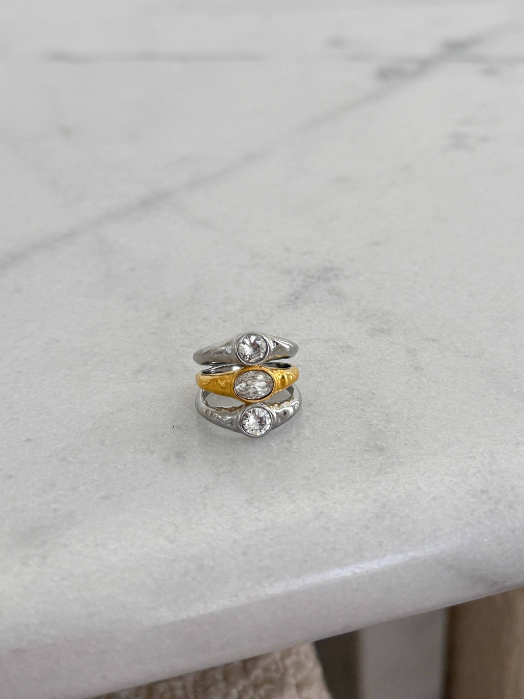 Stack of three rings on a marble surface