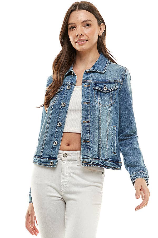 Woman wearing a blue denim jacket over a white top and pants on a white background