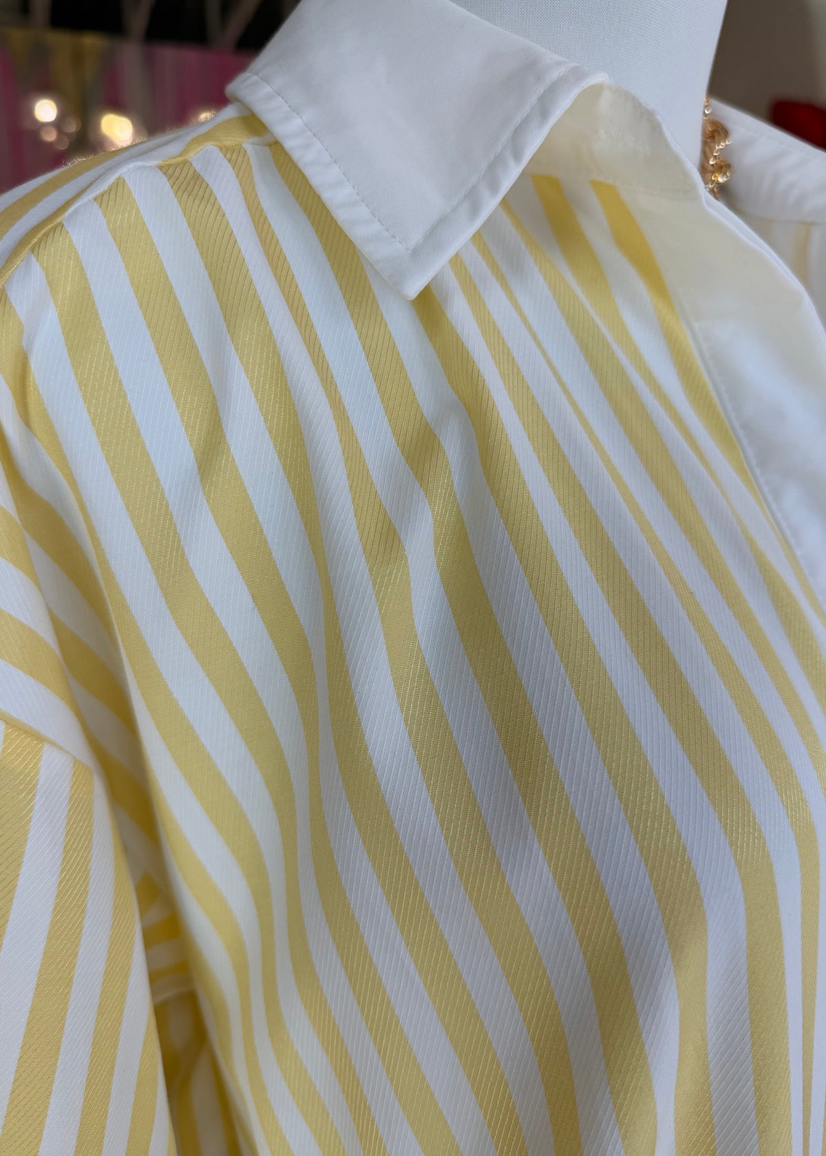 Close-up of yellow and white striped fabric with a blurred background