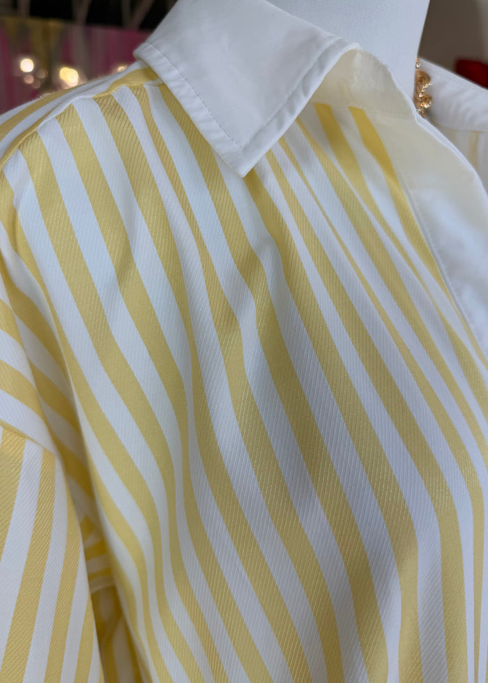 Close-up of yellow and white striped fabric with a blurred background