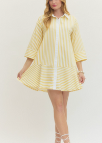 Woman wearing a yellow striped dress on a white background