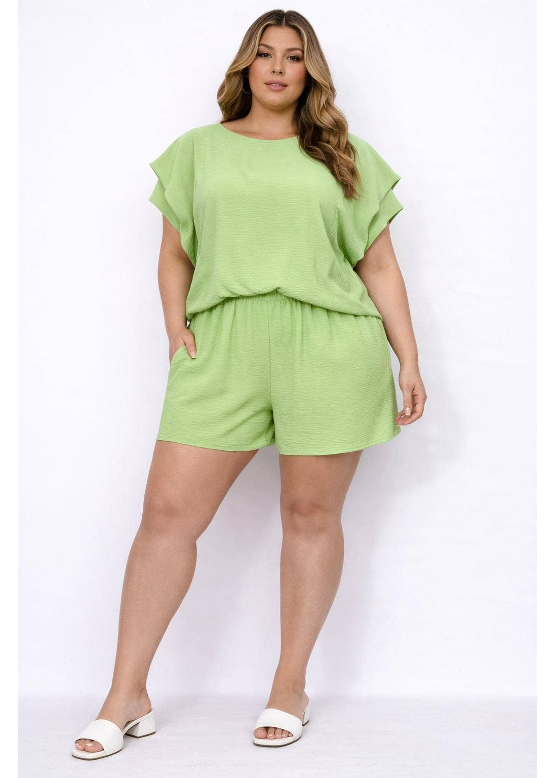 Woman wearing a light green outfit on a white background