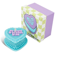 Turquoise oyster-shaped candle with 'It's illegal to be mean to me' text, next to a box with a similar design.