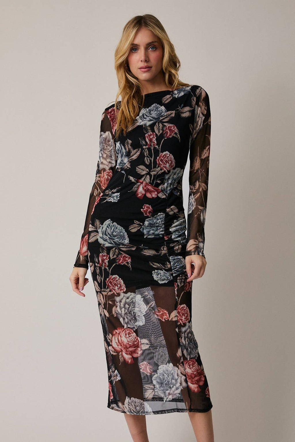 Woman wearing a floral dress with a plain background