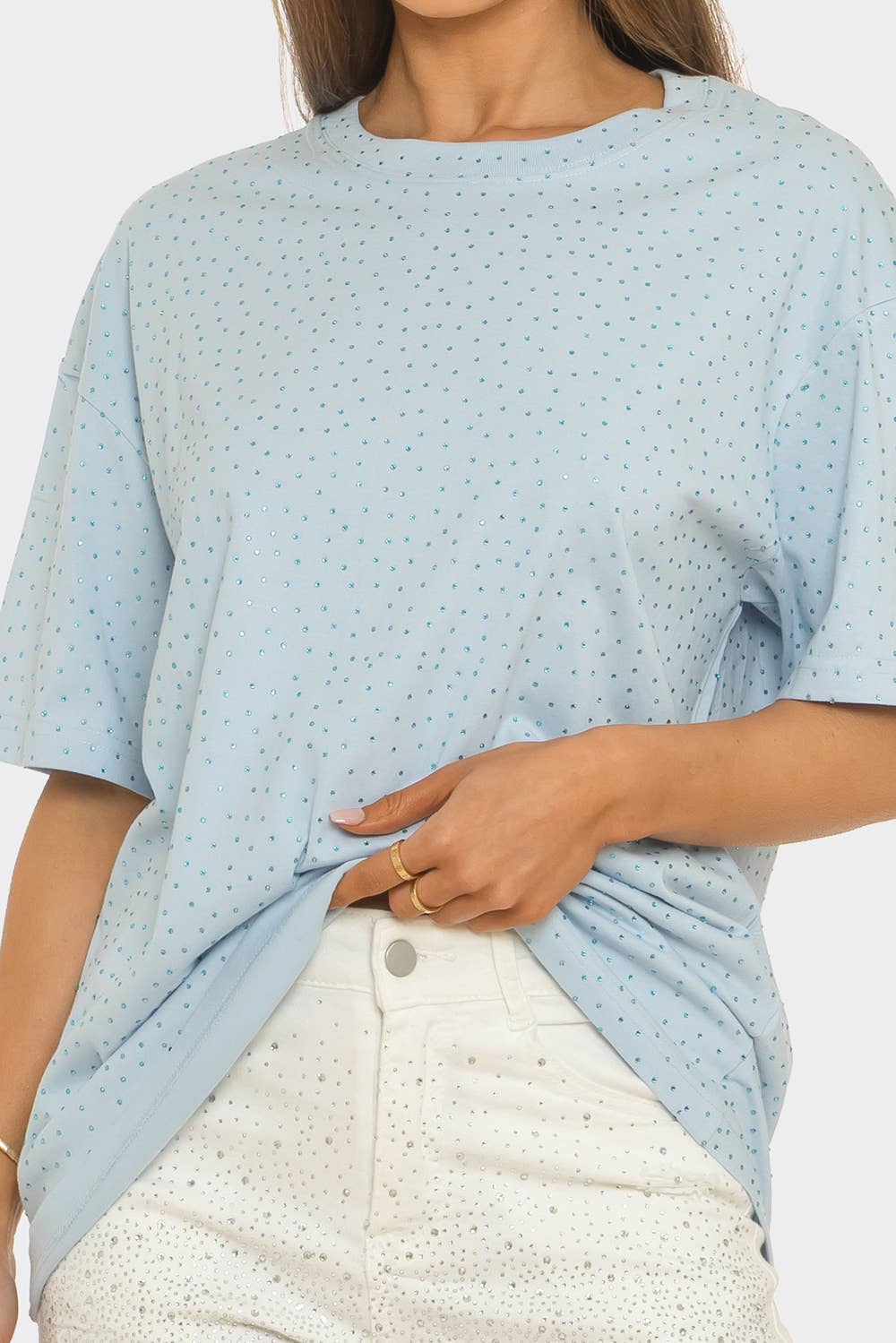 Light blue patterned top worn by a person on a white background