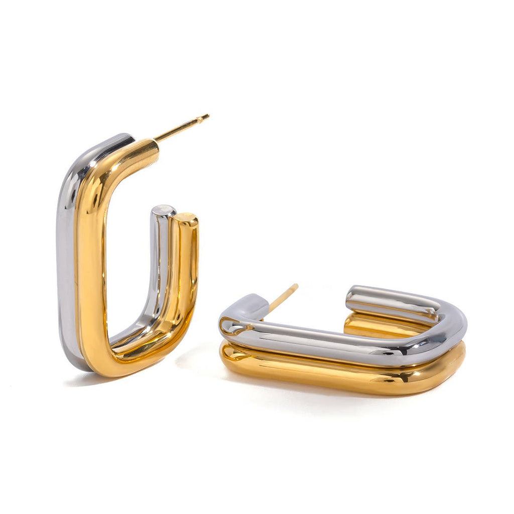 Gold and silver hoop earrings on a white background